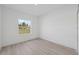 Bright bedroom features a window offering natural light and complemented by sleek, modern flooring at 17315 Sw 26Th Terrace Rd, Ocala, FL 34473