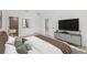 Comfortable bedroom features neutral decor and a television; access to an ensuite bathroom and additional rooms at 17315 Sw 26Th Terrace Rd, Ocala, FL 34473
