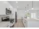 Well-lit kitchen featuring white cabinets, stainless steel appliances, and a large island with bar seating and modern pendants at 17315 Sw 26Th Terrace Rd, Ocala, FL 34473