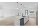 Bright kitchen featuring stainless appliances, white cabinets, and a center island with black faucet at 17315 Sw 26Th Terrace Rd, Ocala, FL 34473