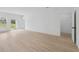 Spacious living room featuring wood-look flooring and large slider to backyard at 17315 Sw 26Th Terrace Rd, Ocala, FL 34473