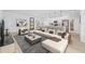 Spacious living room with contemporary furniture and an open concept design flowing into a modern kitchen and dining area at 17315 Sw 26Th Terrace Rd, Ocala, FL 34473