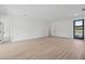 Spacious living room features wood-look flooring and a contemporary design door at 17315 Sw 26Th Terrace Rd, Ocala, FL 34473