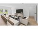 Bright and airy living room with a stylish sectional sofa, contemporary decor, and sliding glass doors to the outside at 17315 Sw 26Th Terrace Rd, Ocala, FL 34473