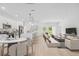Open-concept living space with modern kitchen, cozy living room, and dining area, perfect for entertaining and everyday living at 17315 Sw 26Th Terrace Rd, Ocala, FL 34473
