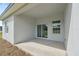 Covered patio area featuring sliding glass doors and windows, ideal for outdoor entertaining and relaxation at 17315 Sw 26Th Terrace Rd, Ocala, FL 34473