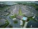 An overhead view of the neighborhood with the community pool, mature trees, and nearby retail at 17322 Chateau Pine Way, Clermont, FL 34711