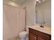 Neutral bathroom featuring a shower-tub combo, single sink with wood vanity, and neutral wall color at 17322 Chateau Pine Way, Clermont, FL 34711