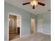 Spacious bedroom featuring neutral carpet, light blue walls, and easy access to bathroom at 17322 Chateau Pine Way, Clermont, FL 34711