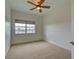 Bedroom featuring carpeting, a ceiling fan, and a window at 17322 Chateau Pine Way, Clermont, FL 34711