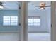 Two bedrooms feature carpeting, neutral paint and ceiling fans at 17322 Chateau Pine Way, Clermont, FL 34711