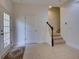 Welcoming foyer with tile flooring, staircase, and natural light from glass door at 17322 Chateau Pine Way, Clermont, FL 34711