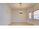 Bright living room with tile floors, natural light, and decorative chandelier at 17322 Chateau Pine Way, Clermont, FL 34711