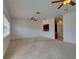 Spacious, carpeted living room with multiple ceiling fans and lots of natural light at 17322 Chateau Pine Way, Clermont, FL 34711