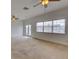 Open living area with carpeting, ceiling fans, and a sliding glass door to a deck at 17322 Chateau Pine Way, Clermont, FL 34711