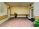 Covered patio with brick pavers, ceiling fan, and two doorways, creating a cozy outdoor space at 17322 Chateau Pine Way, Clermont, FL 34711
