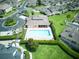 Overhead view of the community pool and amenity center surrounded by condos and mature landscaping at 17322 Chateau Pine Way, Clermont, FL 34711
