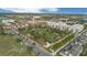 Aerial view of a community featuring a green space, buildings, roads, and lush greenery at 2021 Sweet Birch Ln, Orlando, FL 32828