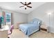 The bedroom is bright and airy, and features light-colored walls and ample natural light at 2021 Sweet Birch Ln, Orlando, FL 32828