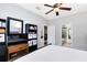 Enjoy this bedroom featuring a large window, a ceiling fan, and an ensuite bathroom at 2021 Sweet Birch Ln, Orlando, FL 32828