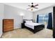 Relax in the comfortable bedroom featuring a ceiling fan, and natural light from a window at 2021 Sweet Birch Ln, Orlando, FL 32828