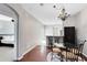 Eat-in dining room featuring wood flooring and chandelier at 2021 Sweet Birch Ln, Orlando, FL 32828