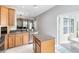 Kitchen featuring an island, stainless steel appliances and a pass-through to living room at 2021 Sweet Birch Ln, Orlando, FL 32828