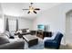 Relax in the living room with high ceilings, plush seating, and bright natural light at 2021 Sweet Birch Ln, Orlando, FL 32828