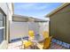 Outdoor patio featuring a brick floor, a white fence, and a round table with four yellow chairs at 2021 Sweet Birch Ln, Orlando, FL 32828
