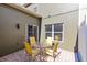View of the outdoor patio featuring a brick floor, an olive green wall, and a round table with four chairs at 2021 Sweet Birch Ln, Orlando, FL 32828