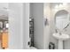 This powder room offers a pedestal sink, neutral paint, and a sleek, modern design at 2021 Sweet Birch Ln, Orlando, FL 32828