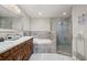 Bathroom featuring double vanity, soaking tub, and a glass enclosed shower with stone surround at 209 7Th S St, Haines City, FL 33844