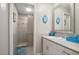This bathroom features a walk-in shower and vanity with white cabinets for ample storage at 209 7Th S St, Haines City, FL 33844