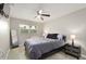 This bedroom offers a view of the outdoors, a ceiling fan, and calming gray tones at 209 7Th S St, Haines City, FL 33844