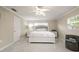 Bright bedroom with neutral tones featuring a plush bed, modern furniture, and ample natural light at 209 7Th S St, Haines City, FL 33844