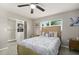 Bright bedroom featuring a ceiling fan, a window and a closet for ample storage at 209 7Th S St, Haines City, FL 33844