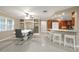 Open floor plan featuring kitchen bar, dining area with built-in shelving, and modern tile flooring at 209 7Th S St, Haines City, FL 33844