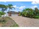 The brick driveway leads to the two-car garage of this brick accented home surrounded by tropical landscaping at 209 7Th S St, Haines City, FL 33844