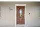 A solid wood front door with glass insert greets visitors to this charming home at 209 7Th S St, Haines City, FL 33844
