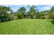 The well-manicured lawn features a fountain and lush tropical landscaping at this brick-accented home at 209 7Th S St, Haines City, FL 33844
