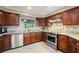Kitchen featuring stainless steel appliances, marble countertops, and dark wood cabinetry at 209 7Th S St, Haines City, FL 33844