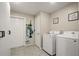 Functional laundry room equipped with modern washer and dryer, plus convenient storage solutions at 209 7Th S St, Haines City, FL 33844
