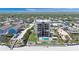 Aerial view of condo building featuring a pool, manicured lawns, parking, and beach access at 2121 Hill St # 7B, New Smyrna Beach, FL 32169