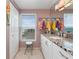 Bright bathroom featuring a granite countertop, white cabinetry, and a window with beach views at 2121 Hill St # 7B, New Smyrna Beach, FL 32169