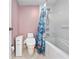 Bathroom with a bathtub, shower, toilet, and privacy door at 2121 Hill St # 7B, New Smyrna Beach, FL 32169