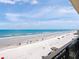 Expansive beach view featuring pristine sand, turquoise water, and blue skies from a private balcony at 2121 Hill St # 7B, New Smyrna Beach, FL 32169