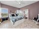 Bedroom features a queen bed, light hardwood floors, and an exterior view at 2121 Hill St # 7B, New Smyrna Beach, FL 32169