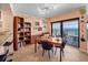 Bright dining area with a bookcase, table, and ocean views with balcony at 2121 Hill St # 7B, New Smyrna Beach, FL 32169
