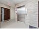 Elevator lobby with an exit sign, elevator, and brick textured walls at 2121 Hill St # 7B, New Smyrna Beach, FL 32169