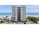 Oceanfront condo building featuring a beautiful beachfront view and well-maintained landscaping at 2121 Hill St # 7B, New Smyrna Beach, FL 32169